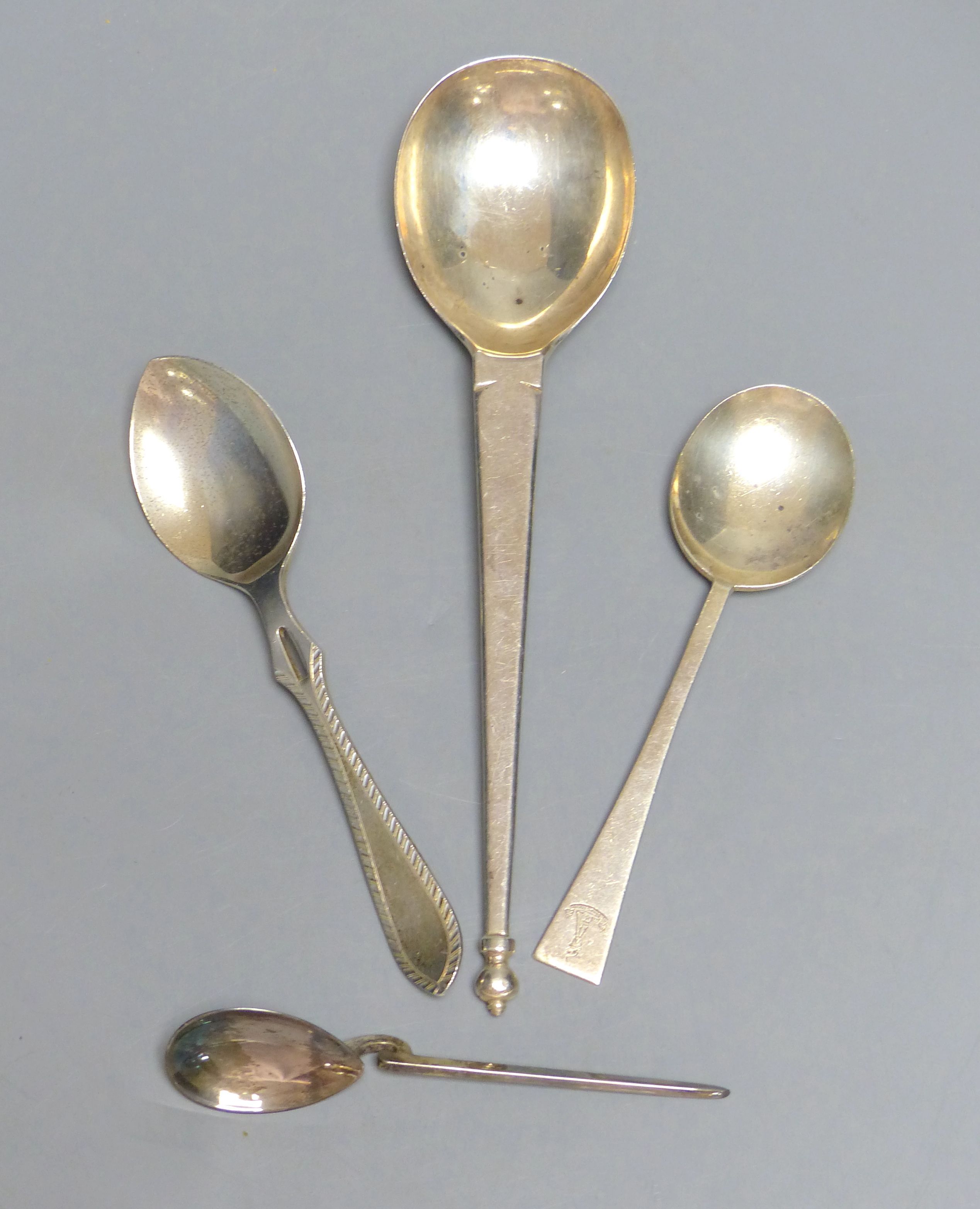 An Arts & Crafts silver spoon with oval bowl and urn finial, George Jackson & David Fullerton, London 1902 and three other spoons